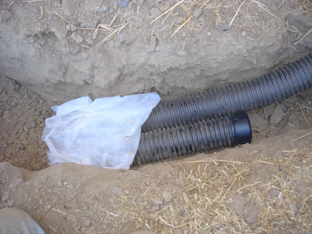 Example: filter fabric and drain pipe in a French drain trench