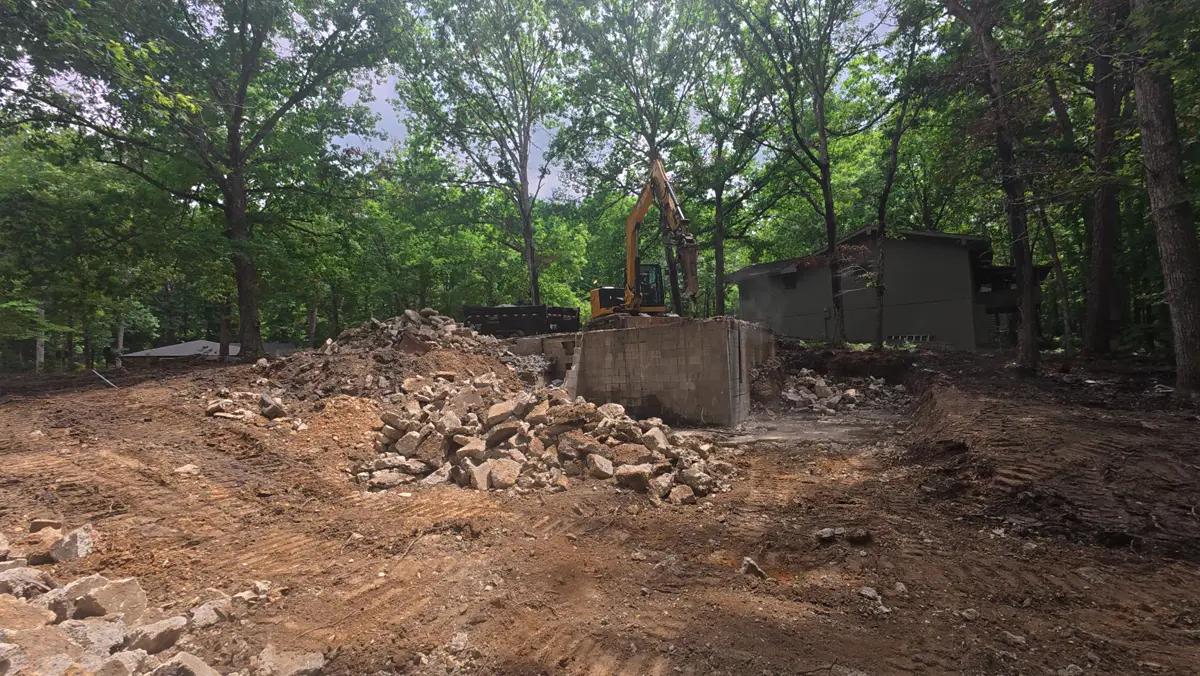 Foundation walls broken out and rubble piled on a cleared lot