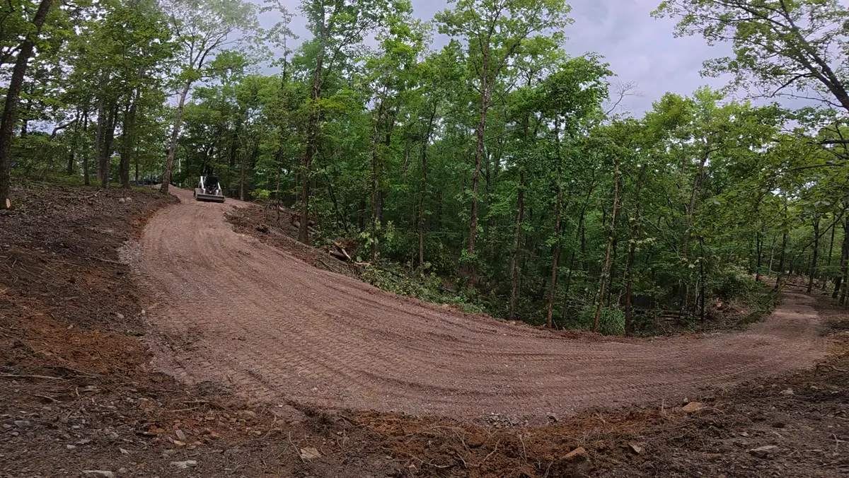 New driveway bed cut and graded through the woods