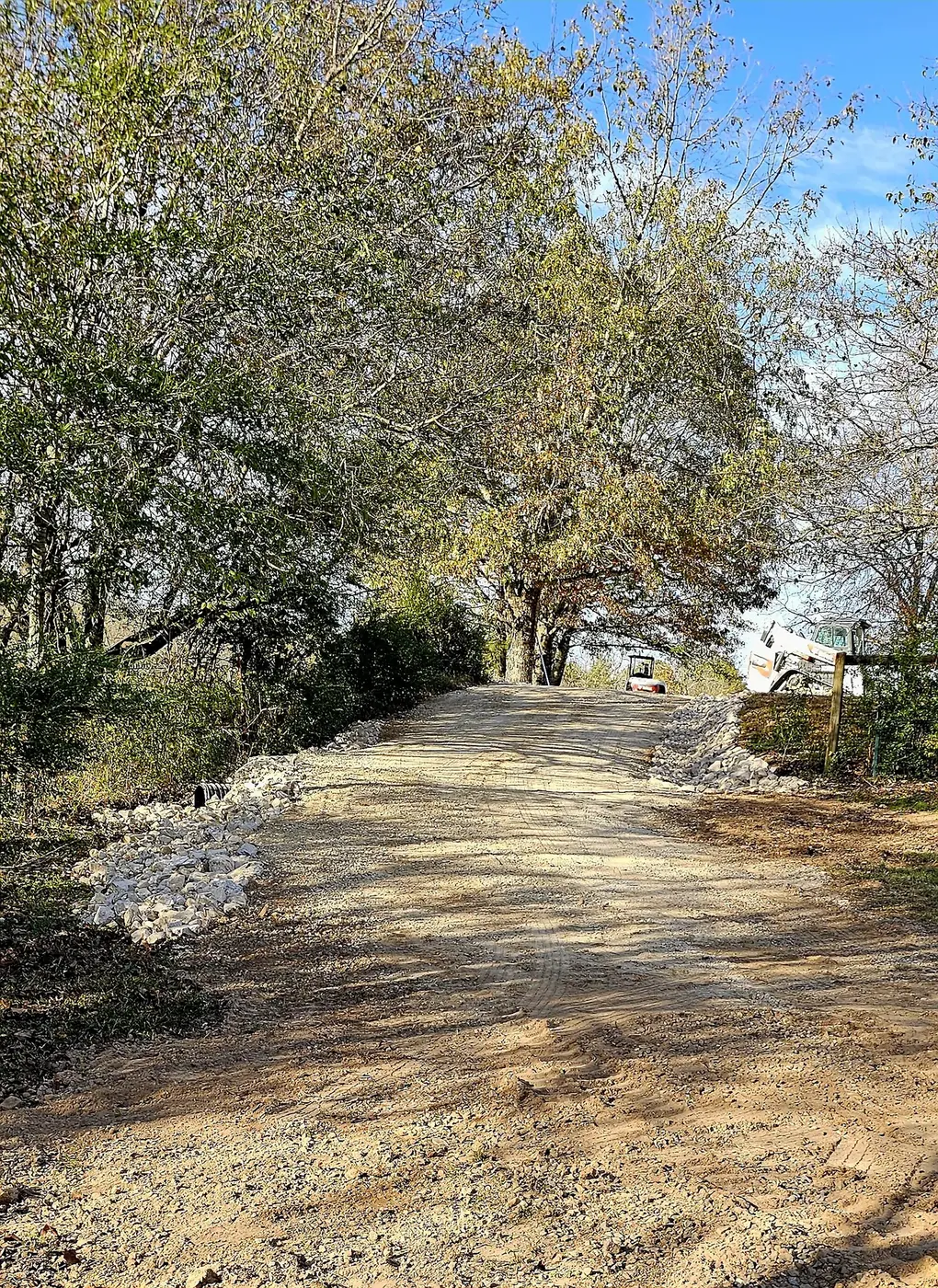 Rock-lined gravel lane after grading work