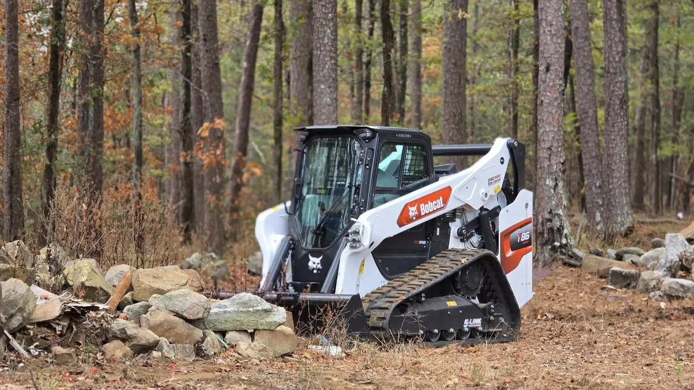 Bobcat T86 at a rocky wooded job site